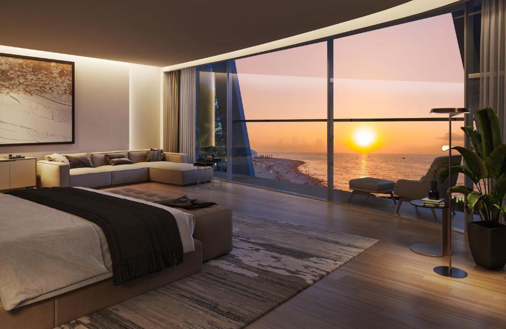 a bedroom with a bed and a view of the ocean at VIP ORBI city A D C in Batumi