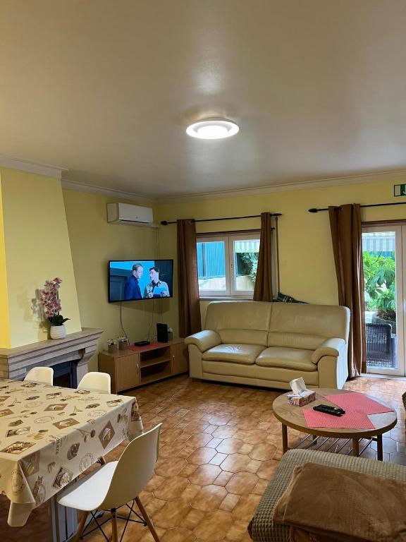 a living room with a couch and a table at Apartamento Solvita in Coimbra