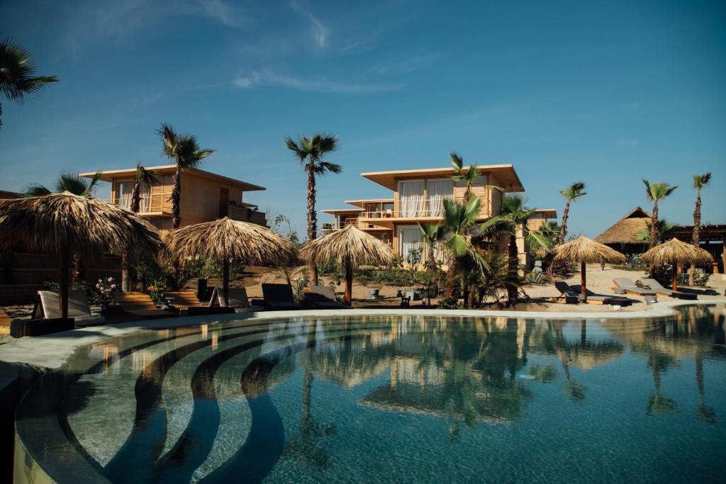a swimming pool in front of a resort at Kymaia Hotel Puerto Escondido in Tlachicón