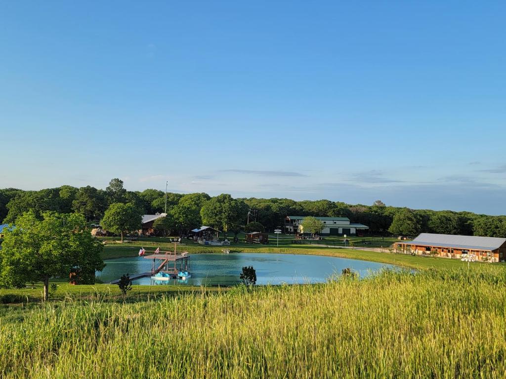 a large pool of water with a playground in it at Private Retreat with Pond, Pool and Hot Tub in Boyd