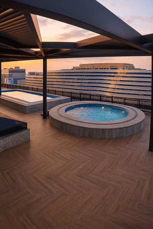a hot tub on the roof of a building at Zeta Mall Luxury Apartments by Wall Street Rooftop Pool Access in Islamabad