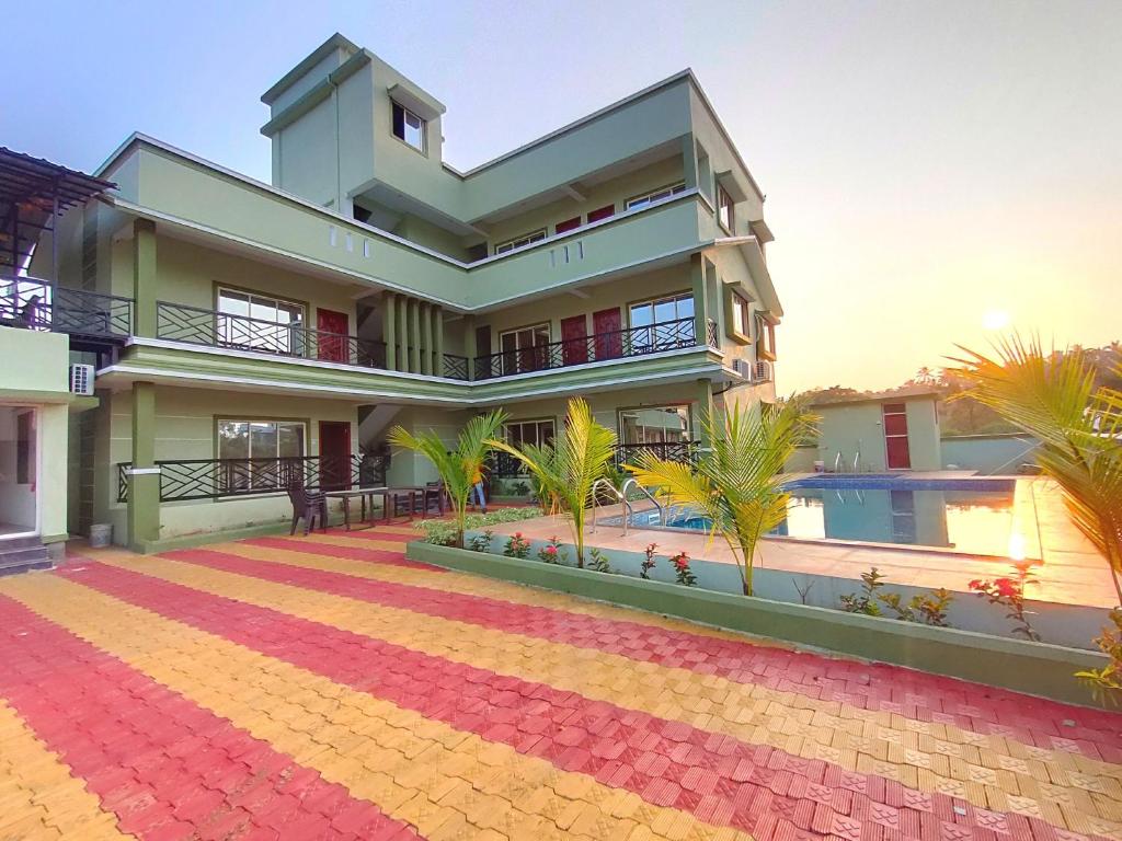 a large house with a pool in front of it at Beach Aura By Lavika Stays in Nagaon