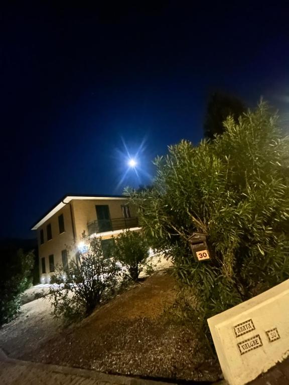 a house on a hill at night with a street light at Amata Valgre Affittacamere, comfort e pulizia eccezionali!! in Olginate