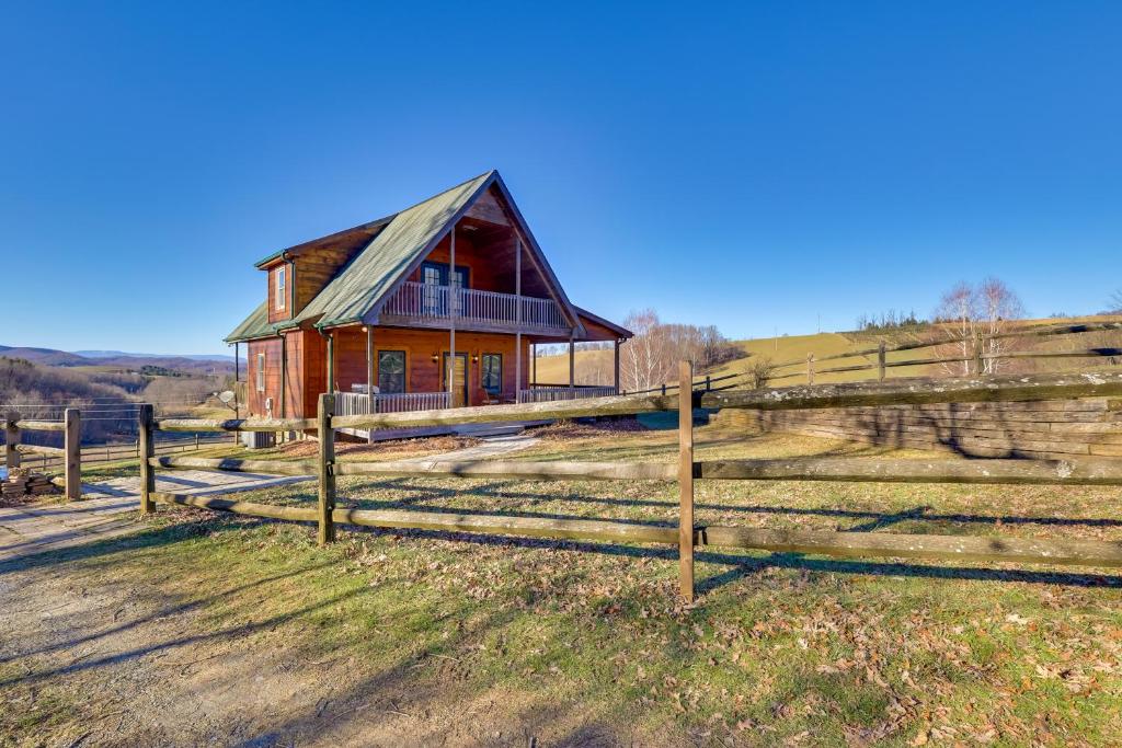 an old barn in a field next to a fence at Decks and Panoramic Views Rustic Sparta Cabin in Sparta
