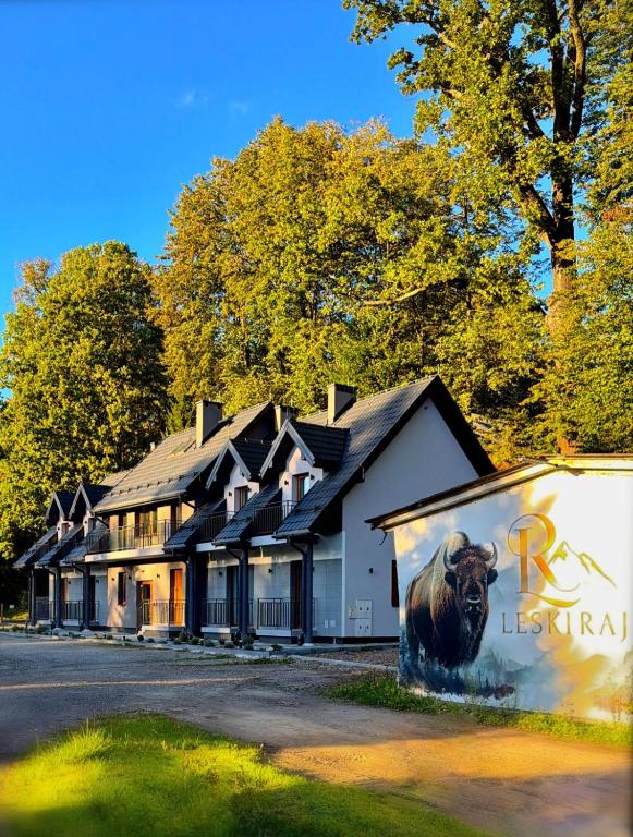 a building with a lion painted on the side of it at Leski Raj in Lesko