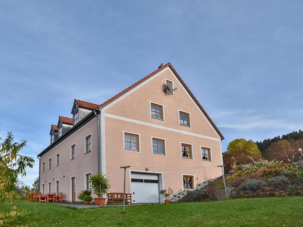 a large white building with a garage at Blumenhof in Dietersdorf