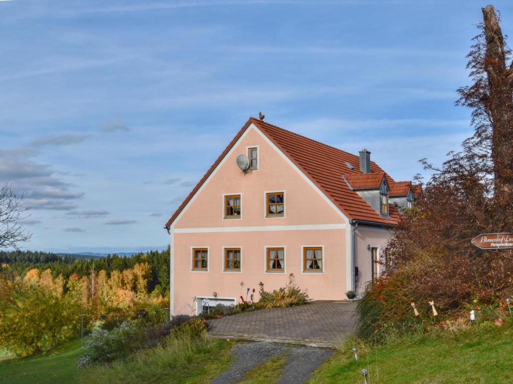 a large white house with a red roof at Blumenhof in Schönsee