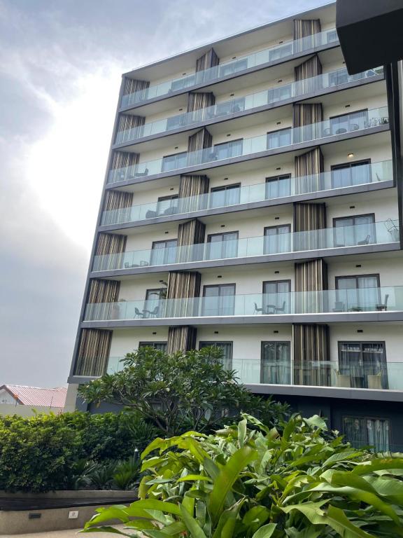 a tall building with trees in front of it at Bloom Styled Studio at The Lennox in Accra