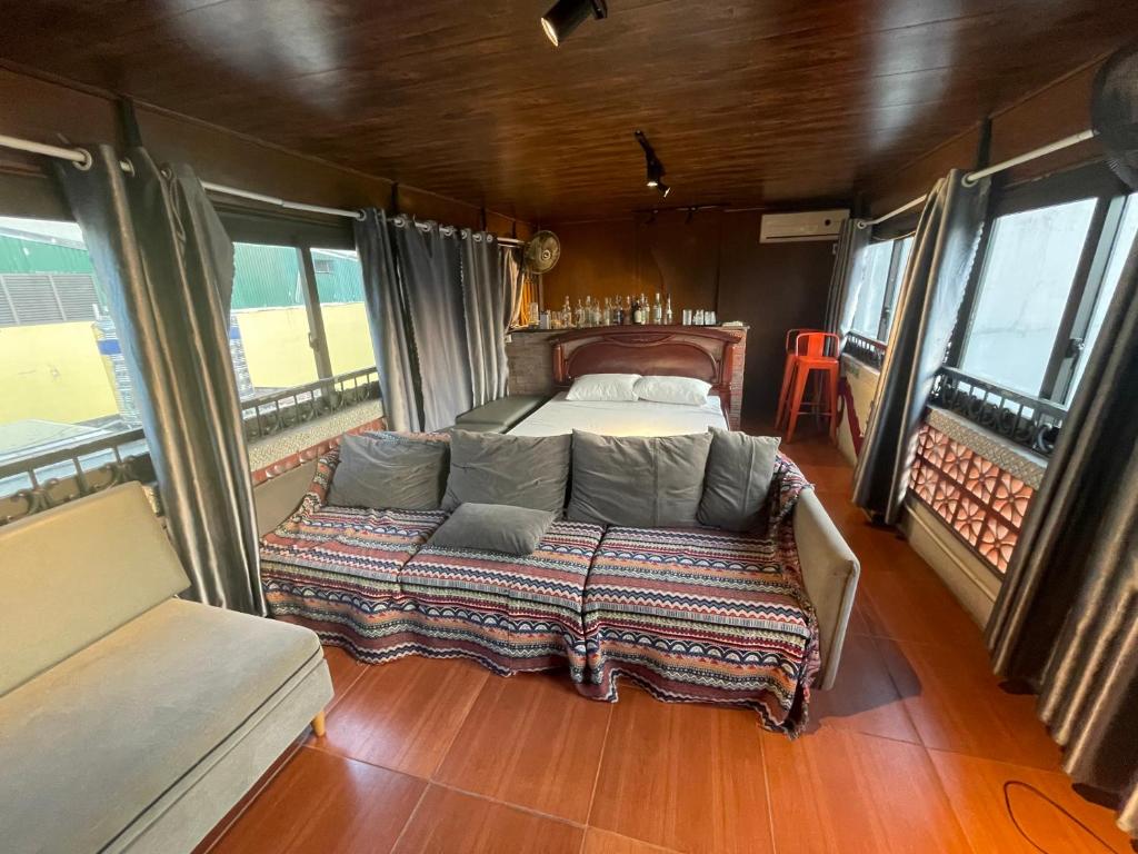 a bed in the middle of a room with windows at Ubuntu Sky view 139 Hang Bac in Hanoi