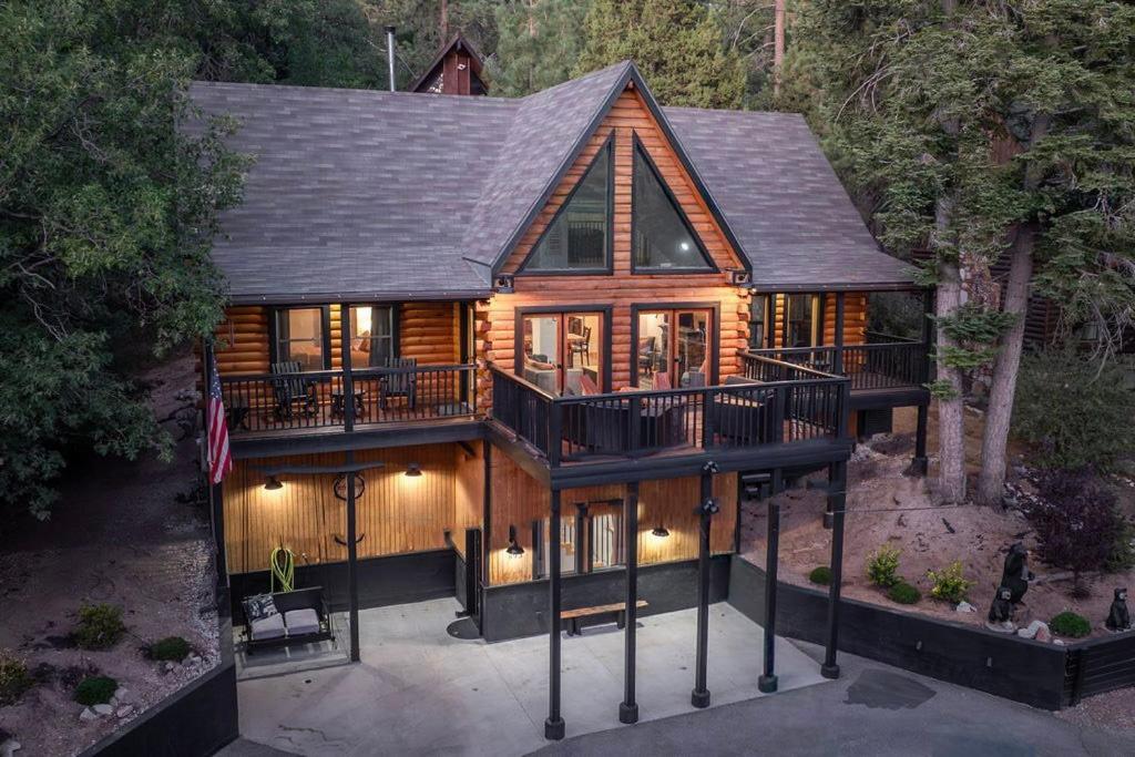 an overhead view of a house with a large deck at Le Vonde Chalet - Luxury log-style, Hot Tub, Game Room, Fire Pit, Walk to Slopes in Big Bear Lake