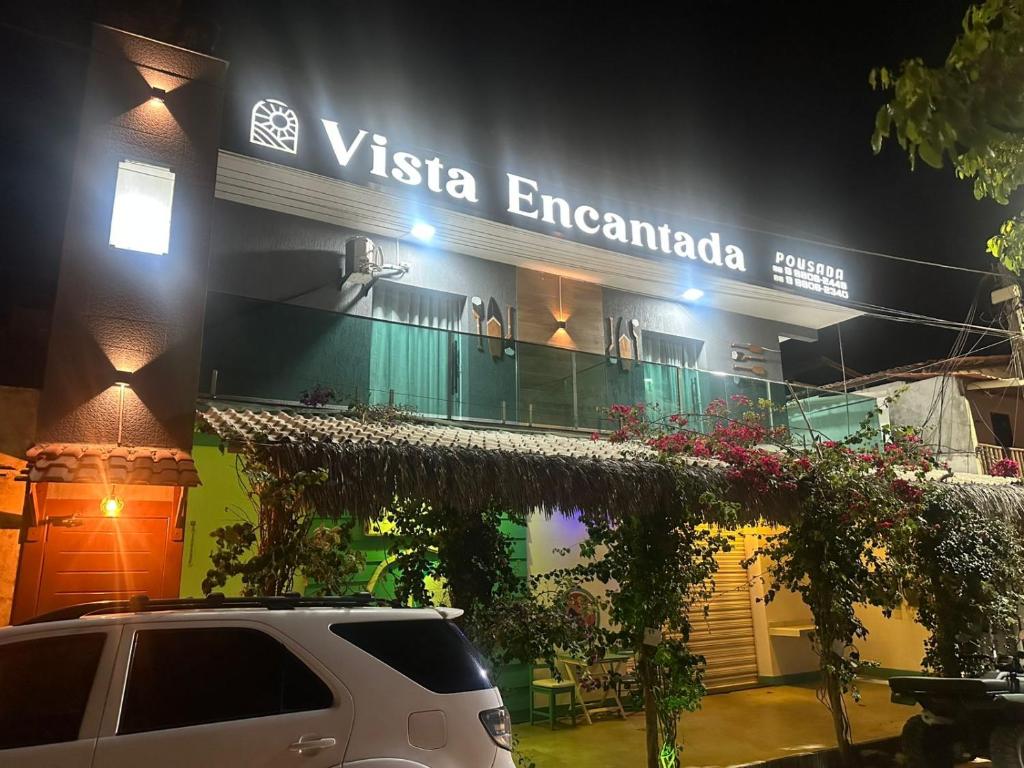 a van parked in front of a building at night at Pousada Vista Encantada Preá in Cruz