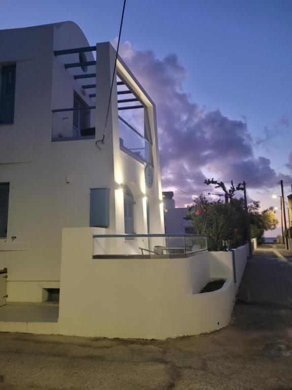 a white building with a window on the side of it at Captain Lazaros Detached Beach Villa and Suites in Perissa