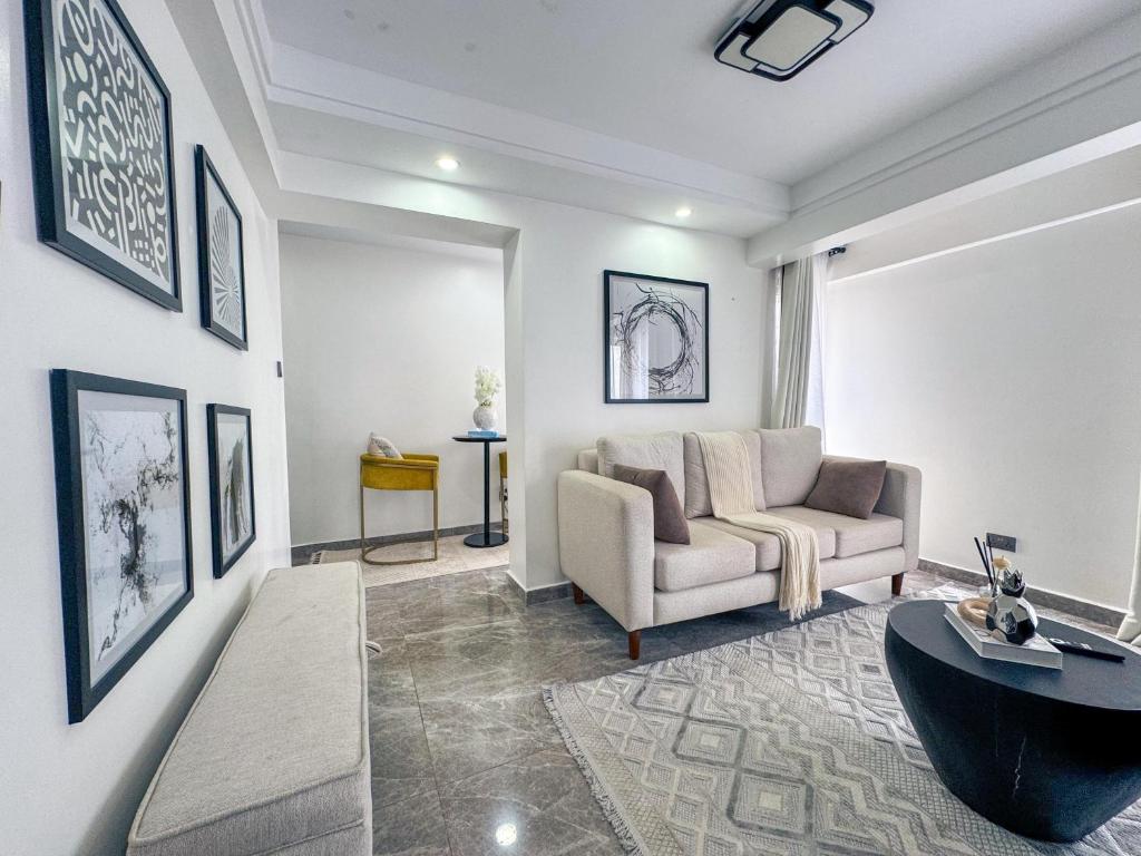a living room with a couch and a table at Getaways homes in Nairobi