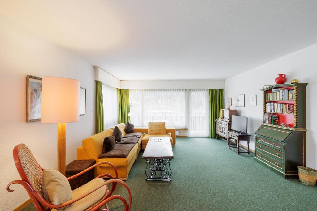 a living room with a couch and a table at Brentsch B51 in Scuol