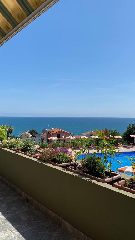 a view of a swimming pool from the balcony of a resort at Cozy Vallevò in Rocca San Giovanni