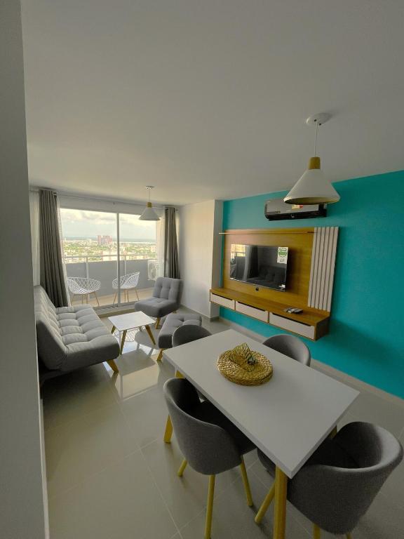 a living room with a table and chairs at Comfort and spectacular views in Barranquilla! in Barranquilla