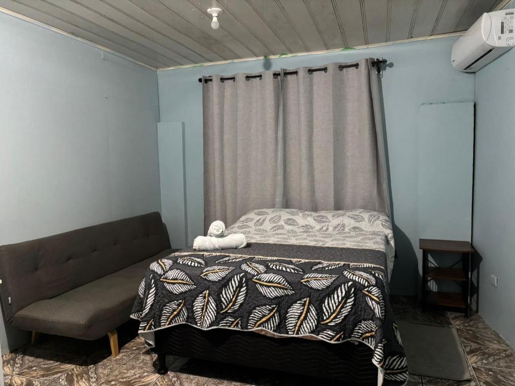 a bedroom with a bed and a curtain at Apartamentos M&M in Fortuna