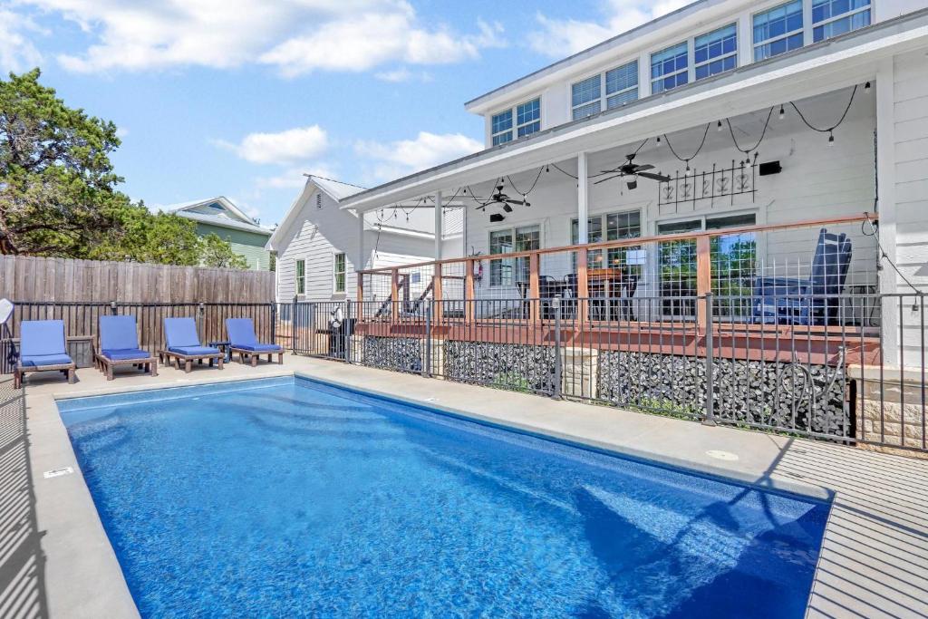 a swimming pool in front of a house at Stone Ridge Retreat in Canyon Lake