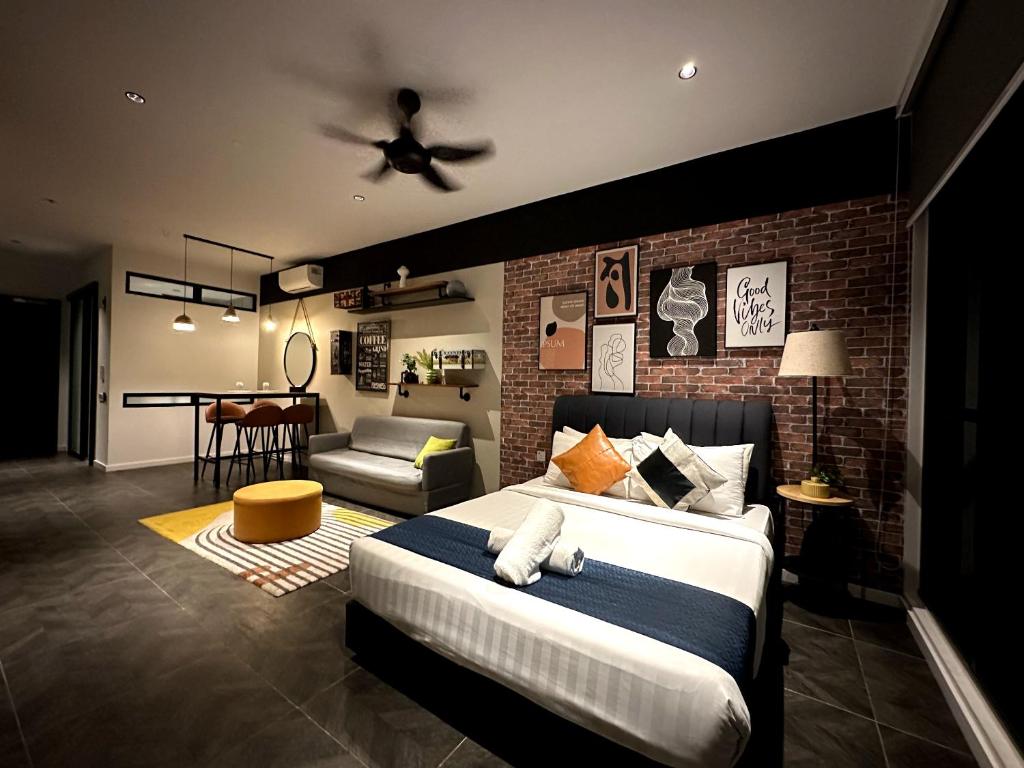 a bedroom with a bed and a brick wall at Scarletz suites klcc Twin Tower by ESD in Kuala Lumpur