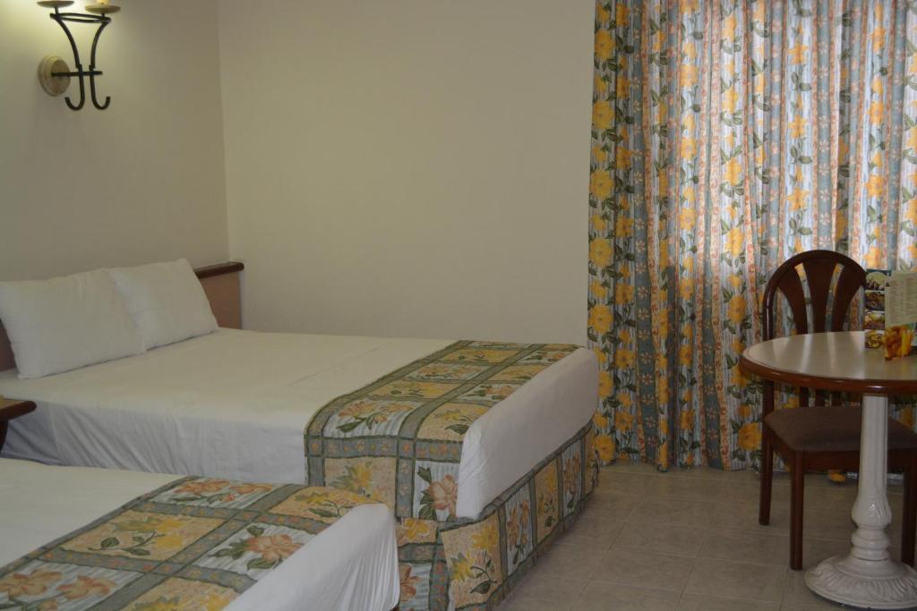 Postel nebo postele na pokoji v ubytování Hotel Ruiz Milán