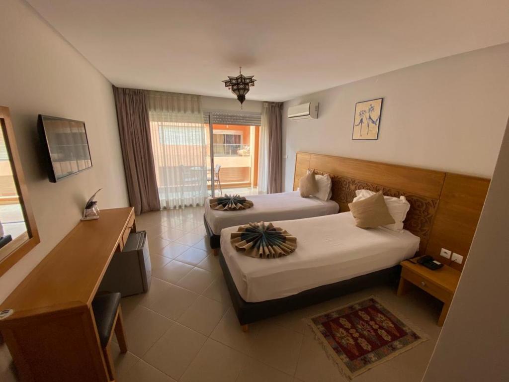 Ένα ή περισσότερα κρεβάτια σε δωμάτιο στο Hotel Residence Imiplage