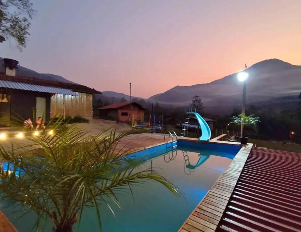 a villa with a swimming pool at sunset at Hospedaje Vildumar in Pichilemu