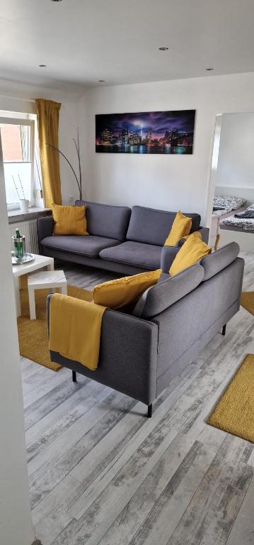 a living room with a blue couch and yellow pillows at Sonne in Lünen
