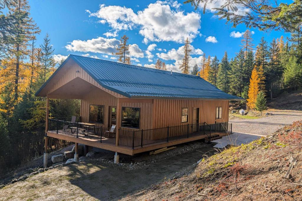 a cabin in the woods with a blue roof at Rocky Crest Retreat in Somers