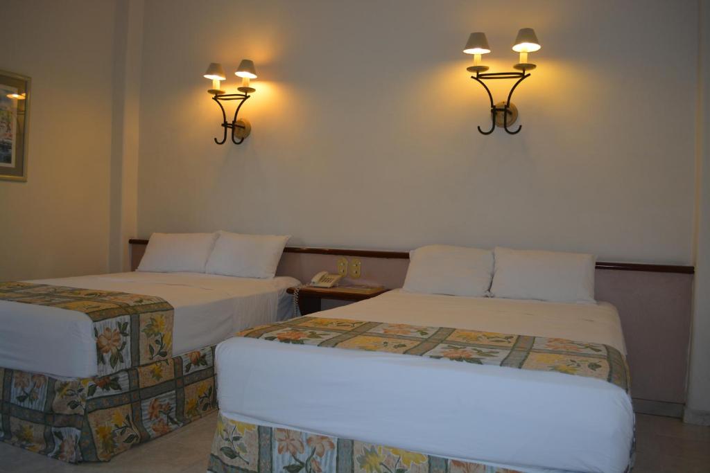 Postel nebo postele na pokoji v ubytování Hotel Ruiz Milán