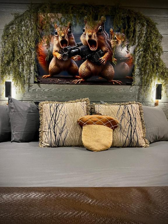 two bears playing a video game with a gun painting at "Squirrels Gone Wild" Luxury Treehouse Adventure Near Dollywood & Pigeon Forge in Sevierville