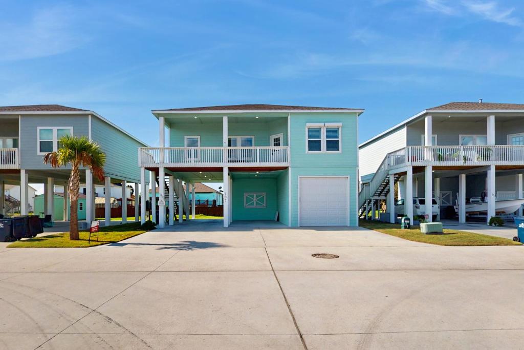 a row of apartment buildings with a driveway at Gulf Breeze in Rockport