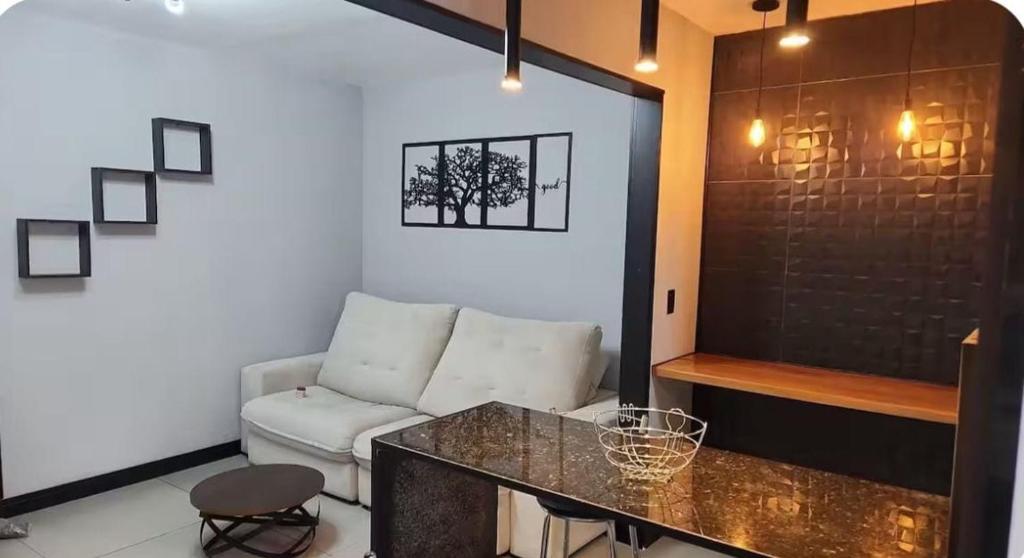 a living room with a couch and a table at Modern Apartment in São Caetano do Sul in São Caetano do Sul