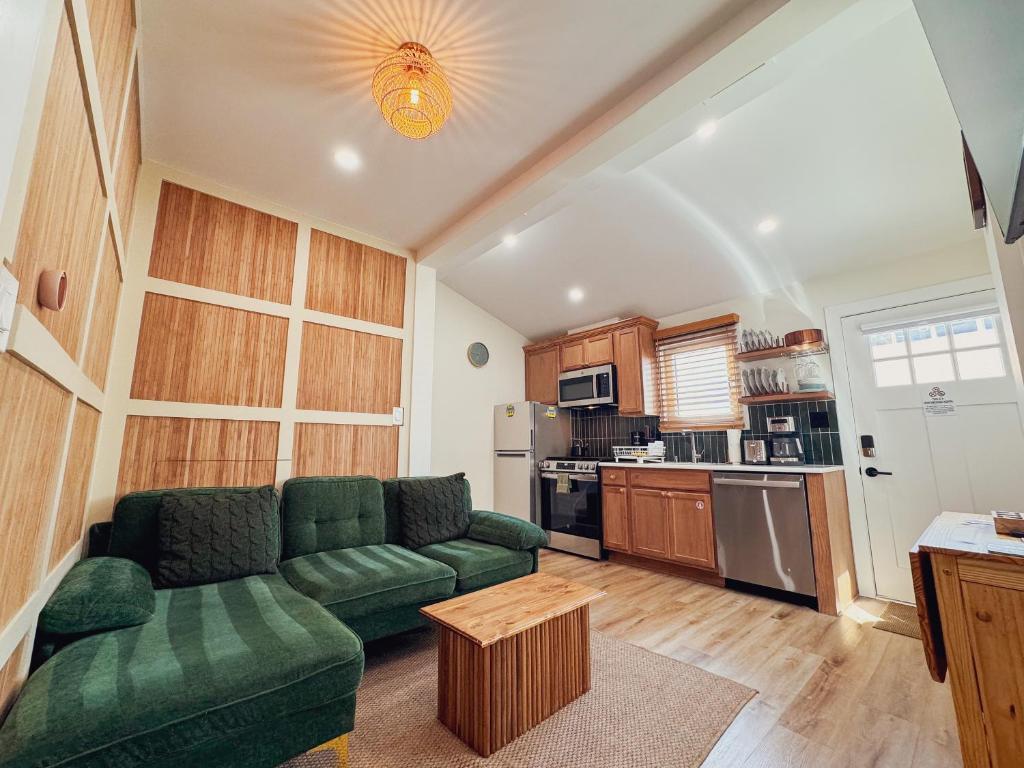 a living room with a green couch and a kitchen at Stylish 2 BR 1 BA Apartment - Steps to the Ocean - Hidden Gem in Wildwood