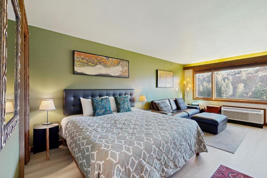 a bedroom with a bed and a couch and a window at Million Dollar View- 419 in Rockwood
