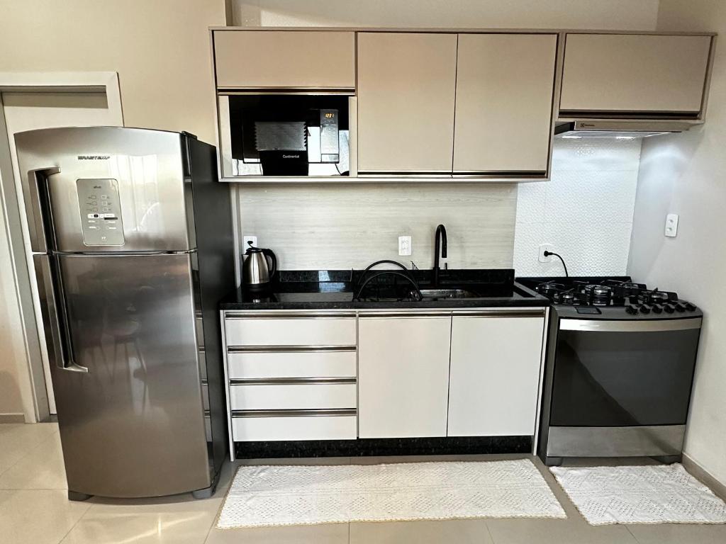 a kitchen with a stainless steel refrigerator and a stove at Casa moderna em Videira in Videira