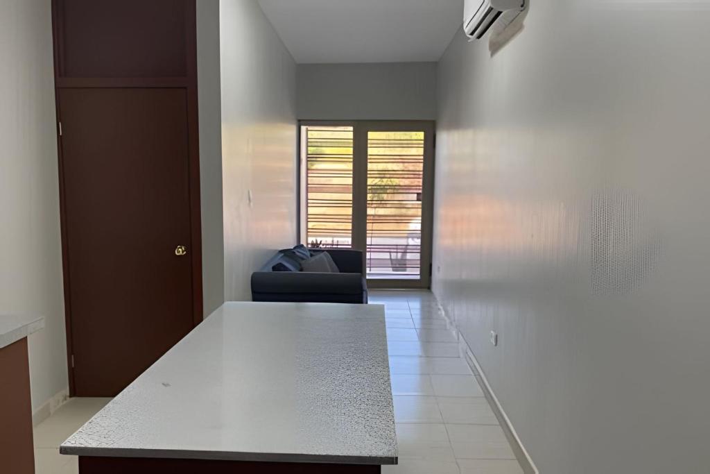 a room with a table and a chair in it at Casa Madre Perla - a 2 min de la Playa Miramar in Colonia Miramar