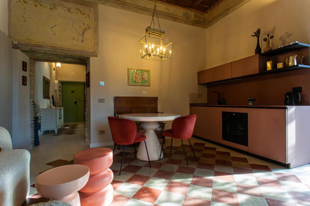 a kitchen with a table and red chairs at Appartamento con terrazza La Voliera di Bacco in Frascati