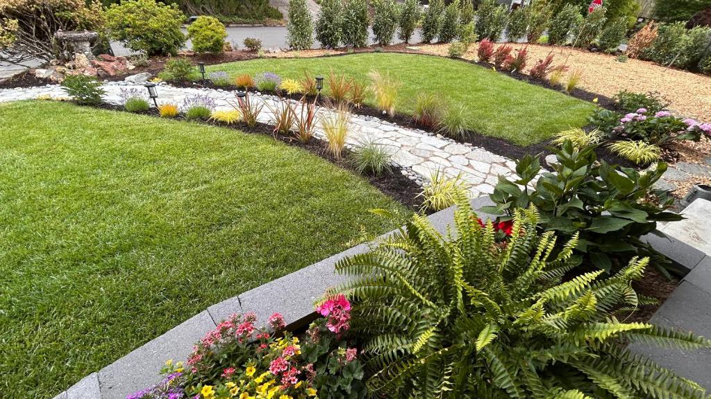 a garden with many different flowers and plants at Evergreen Garden close to Downtown Portland Beaverton next to St Vincents Hospital in Portland