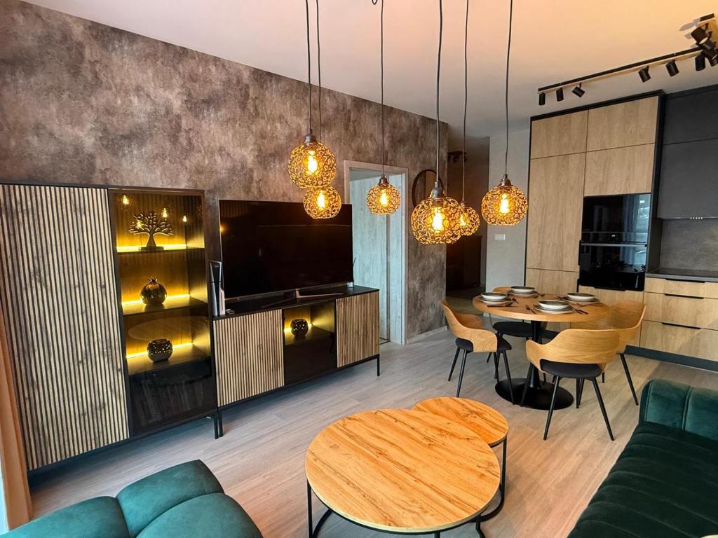 a living room with a table and a dining room at Apartmán Lottner in Kysucké Nové Mesto