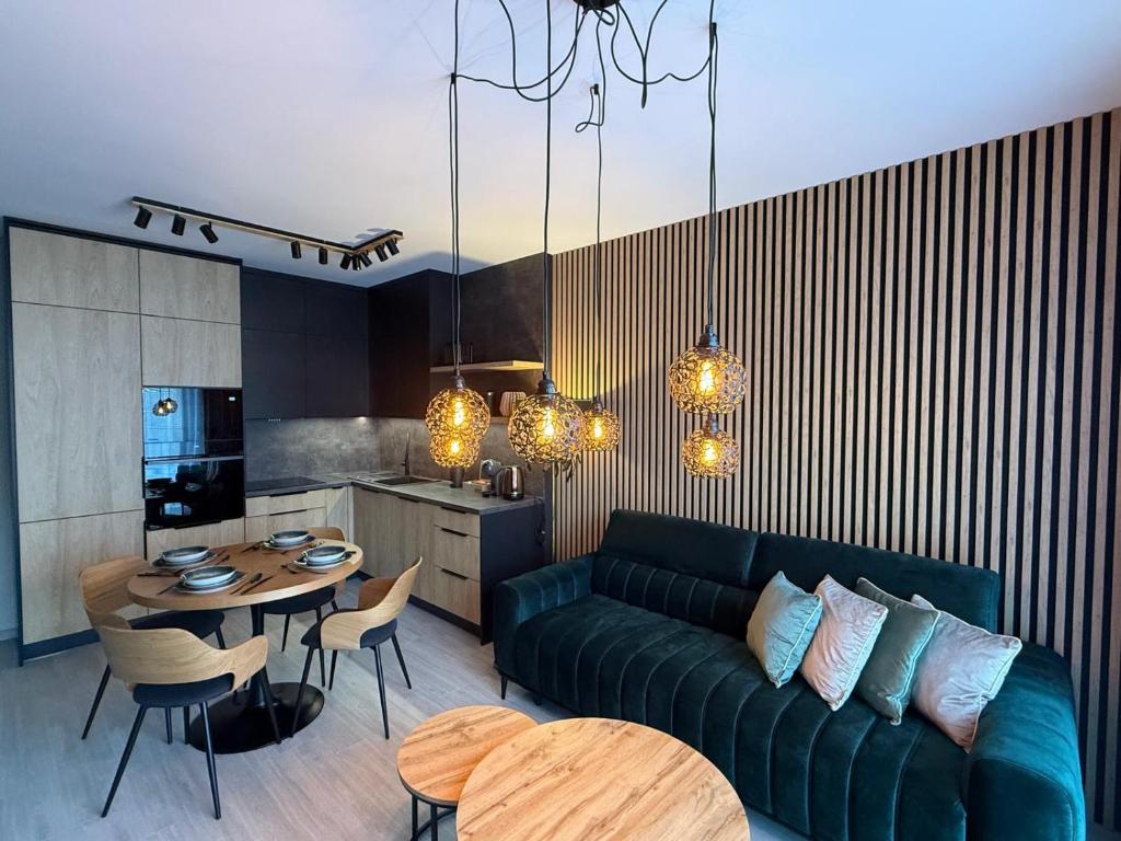 a living room with a couch and a table and a kitchen at Apartmán Lottner in Kysucké Nové Mesto