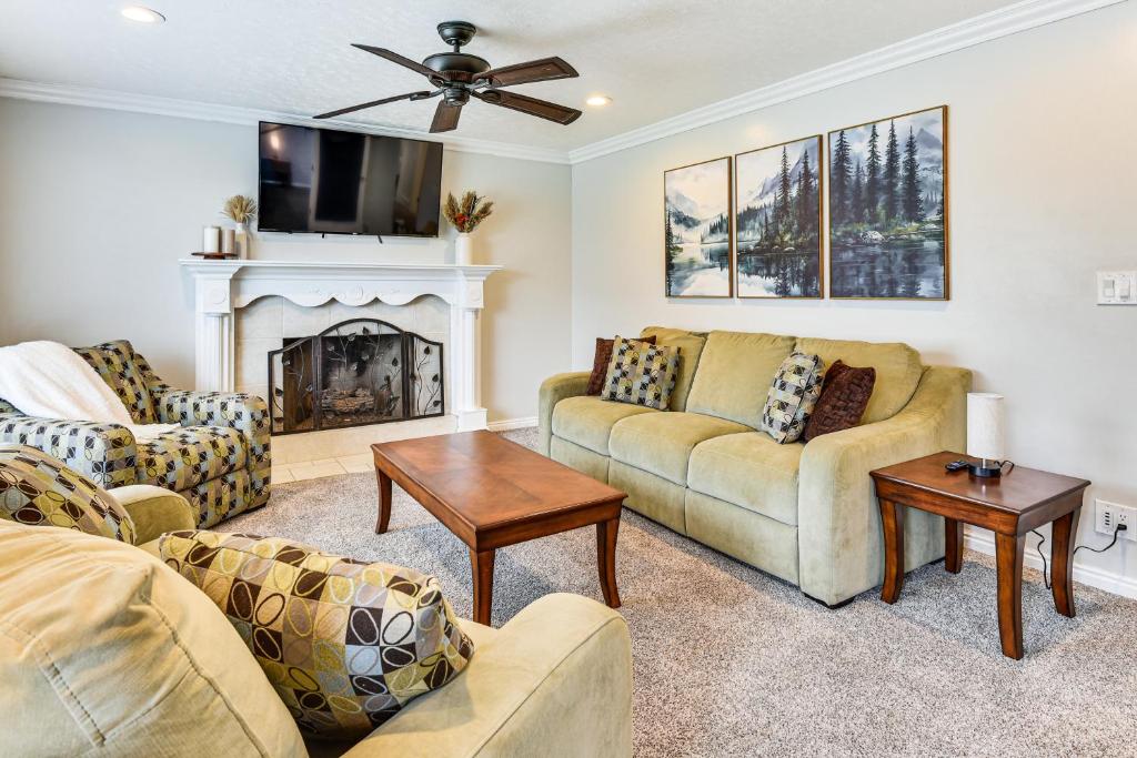a living room with two couches and a fireplace at Mountain-View Retreat with Hot Tub in Centerville! in Centerville