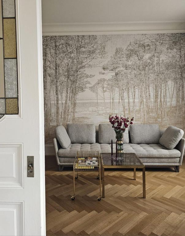 a living room with a couch and a table at Apparemment de style 70s in Colmar