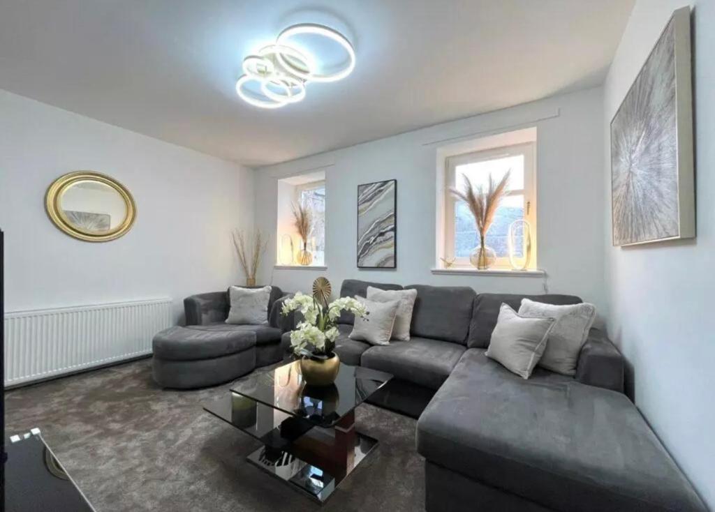 a living room with a couch and a table at Cosy Hideaway in Stirling