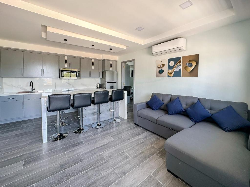 a living room with a couch and a kitchen at Apt Four A #4 in Punta Penasco New