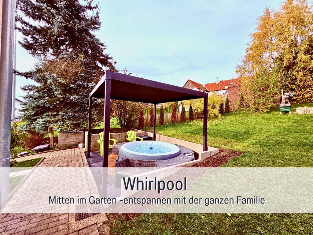 a pavilion with a hot tub in a yard at Nur 15 Minuten bis Fulda - ideal zum Arbeiten - Am Vulkanradweg - 3 Schlafzimmer Große Terrasse - Grill - Ferienhaus Taufstein 1 in Herbstein