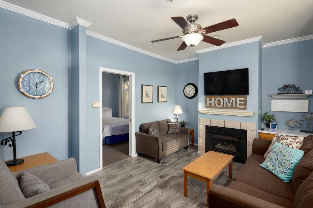a living room with a couch and a fireplace at Sandbar Escape in Oceano