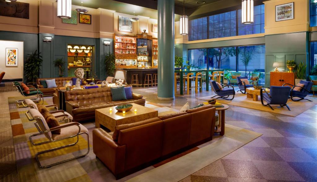 a lobby with couches and chairs and a bar at The Barnett, part of JdV by Hyatt in New Orleans