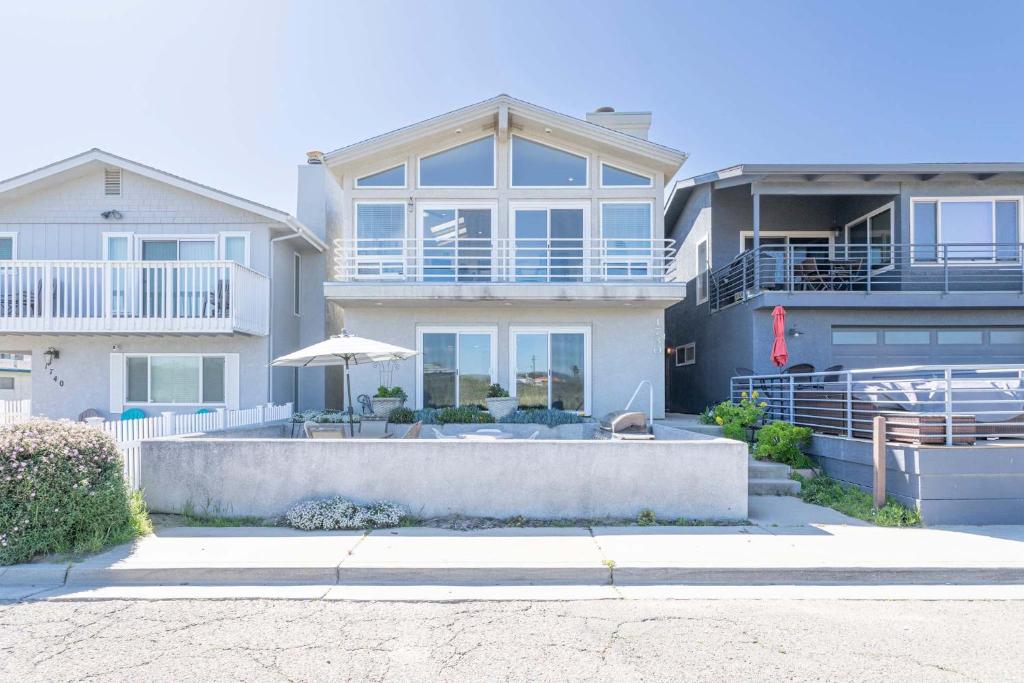 a large house with an umbrella in front of it at Oceano Lagoon in Oceano