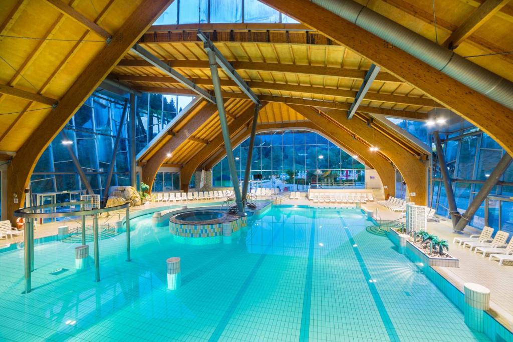 a large indoor swimming pool with a large ceiling at Apartments in Laze V Tuhinju - Julische Alpen 50144 in Srednja Vas pri Kamniku