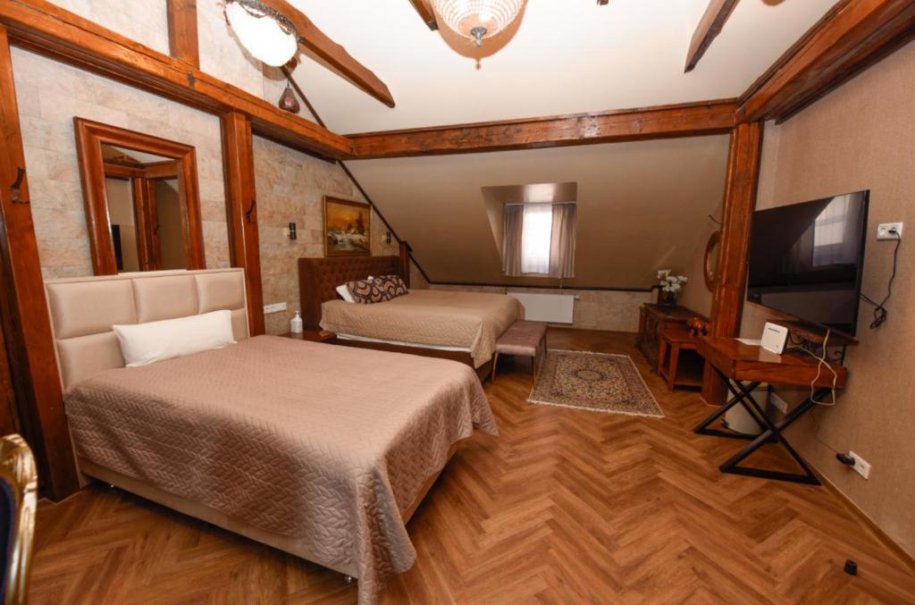 een slaapkamer met twee bedden en een flatscreen-tv bij Haus Thomas Penthouse Deluxe in Dortmund